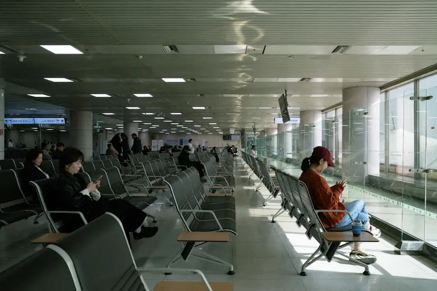 Passengers waiting in modern airport departure lounge